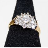 A 9ct gold dress ring, set with various layers of CZ stones, ring size N½, 2.2g all in.