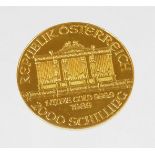A 1989 Austrian gold Philharmonic coin, marked 1 unze gold, 999.9, 2000 Schilling.