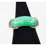 An 18ct white and yellow gold jade dress ring, with curved pale green jade central panel, held by tw
