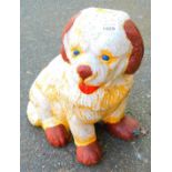 A painted garden ornament, standing dog.