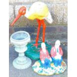 A metal garden statue stork, another vase and a Laurel & Hardy statue. (3)