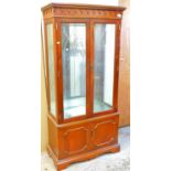 A mahogany finish display cabinet.