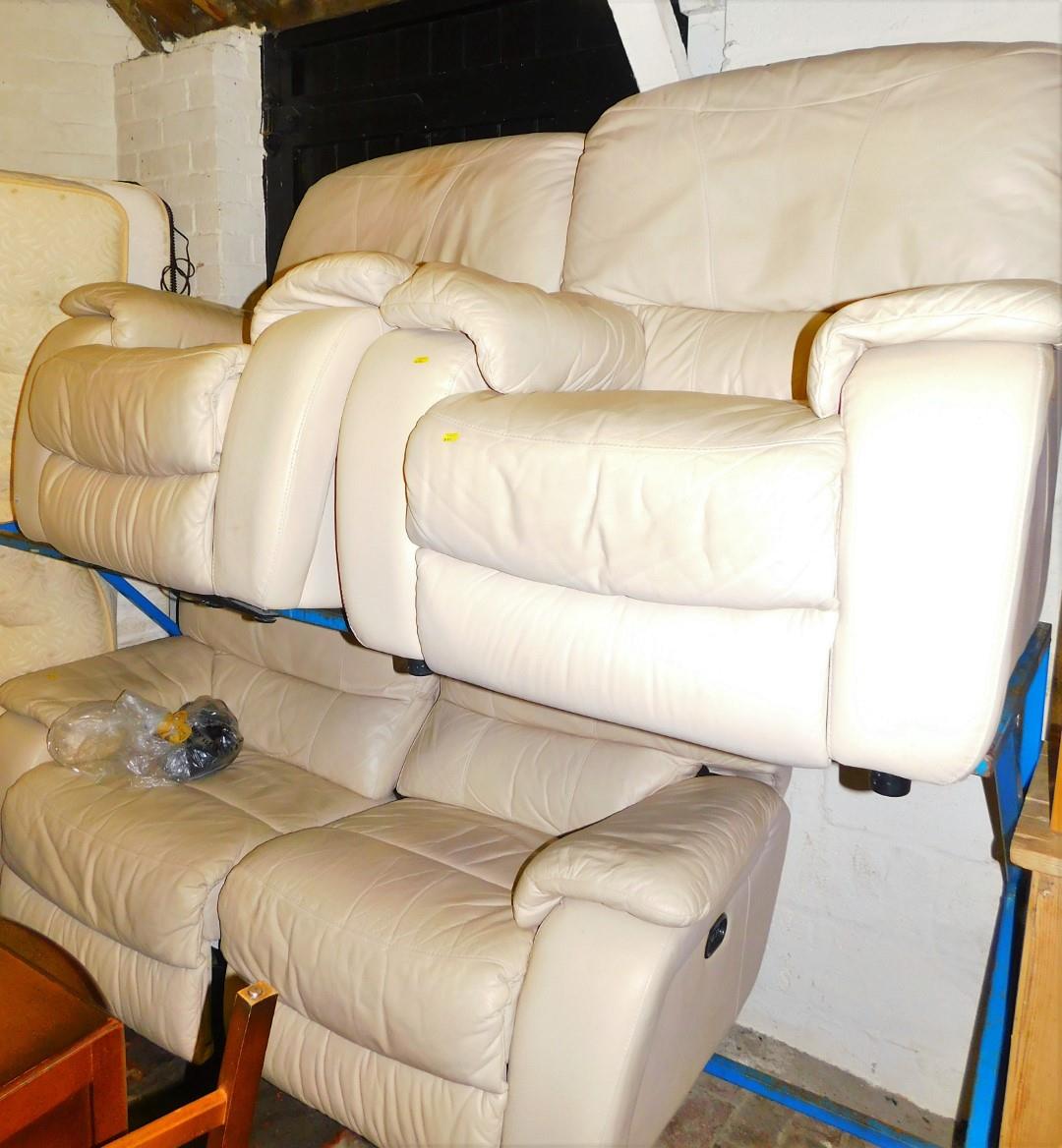 A cream leather electric reclining three piece suite.