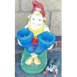 A painted garden gnome as a two sectional planter and a bootpull shaped as a beetle.
