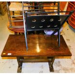 An oak finish side table, newspaper rack and a folding chair.