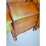 A mahogany finish bureau, with flame mahogany fall front.