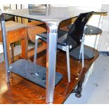 A modern curved glass top office desk, and associated chair.