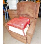 An armchair with leather finish cushion and a canvas topped box. The upholstery in this lot does not