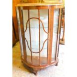 A Compas Product walnut bowfronted display cabinet.