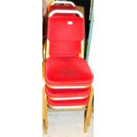 A set of six conference chairs, with overstuffed back and seats in red material with gilt coloured m