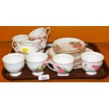 A Colclough part tea service, decorated with flowers, to include milk jug, sugar bowl, tea cups and