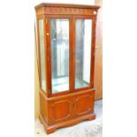 A mahogany finish display cabinet.