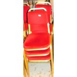 A set of six conference chairs, with overstuffed back and seats in red material with gilt coloured m