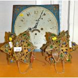 A painted longcase clock face and two metal star shades.