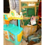 A Boltt sewing machine table with sewing machine and a child's plastic kitchen
