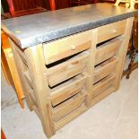 A kitchen cabinet, set with metal top and removable drawers and compartments.