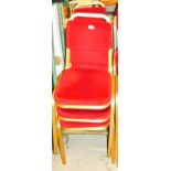 A set of six conference chairs, with overstuffed back and seats in red material with gilt coloured m