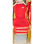 A set of six conference chairs, with overstuffed back and seats in red material with gilt coloured m