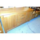 A light wood sideboard and a television cabinet.