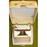 A cased Olympic typewriter.