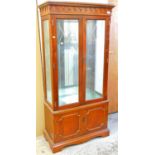 A mahogany finish display cabinet.