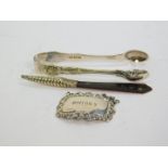 A pair of Edward VII King's pattern sugar tongs, Sheffield 1903, 1.43oz, Whiskey decanter label,