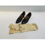 A pair of early 20thC lady's black leather shoes, with paste set buckles and a pair of lady's long