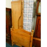 A pine single bed, with pine head board, foot board and two side boards with slats and a single