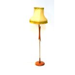 A Vintage 1950's teak brass rod standard lamp, raised on a circular base, with shade, 142cm H.