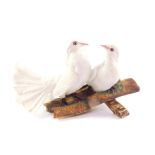 A Capo di Monte porcelain figure group of two white fan tailed doves, signed V Buisch, 19cm H.