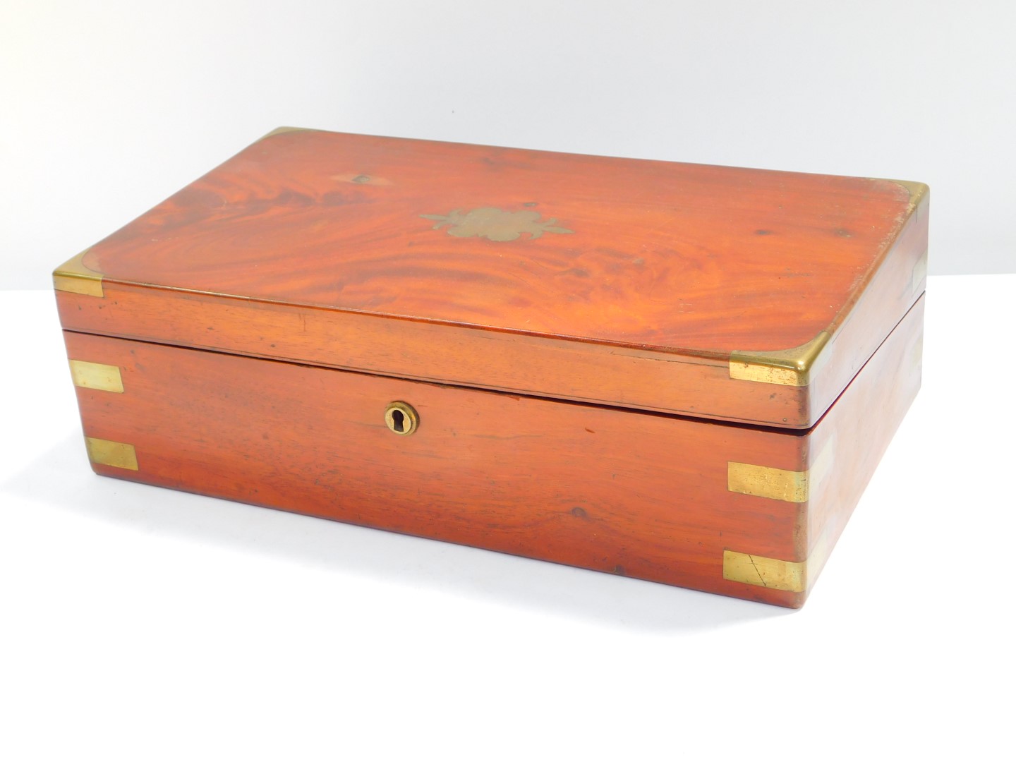 A Victorian mahogany and brass bound writing slope, opening to reveal a slope and fitted interior,