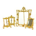 A brass rococo style strut photograph frame, cast with scrolling leaves, flowers and a shell, 44.5cm