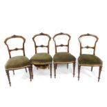A set of four Victorian walnut single dining chairs, with leaf and hairbell carved crest rail and