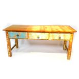 A stripped and painted pine farmhouse kitchen table, the triple plank top over three frieze drawers,