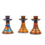 A pair of Gouda Pottery candlesticks, decorated in the Lurette patten, No 155, painted marks, 14cm