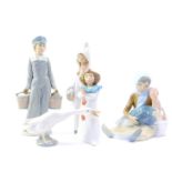 Four Lladro porcelain figures, comprising a boy carrying two water buckets, girl in nightgown,