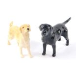 A Beswick model of a standing black labrador, 8cm H, together with a Beswick model of a standing