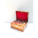 A Victorian rosewood travelling box with mother of pearl escutcheon, the hinged lid opening to
