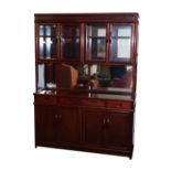 A Chinese hardwood mirror back sideboard, the pediment over two pairs of glazed doors, enclosing