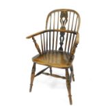 A 19thC oak and elm Windsor chair, with pierced vase shaped splats, solid saddle seat raised on