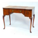 An early 20thC walnut breakfront desk, with a central square tooled leather writing surface above