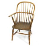 A 19thC oak and elm Windsor chair, with solid saddle seat, raised on turned legs united by an H