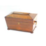 A Regency rosewood tea caddy of sarcophagus form, with ring handles, the hinged lid opening to