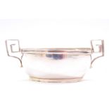 A George III silver salt, of oval form with Greek key scroll handles, with glass liner, John Emes,