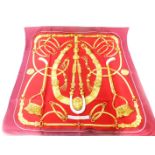 A Hermes red Gaucho silk scarf, boxed, 89cm x 87cm.