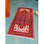 A Qum wool rug, decorated with fourteen guls, four fish, flowers and a vase and birds, within a