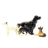 A Beswick model of a black spaniel in standing pose, 14cm H, and three further Beswick dogs,