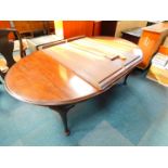 A Victorian mahogany wind out dining table, with three and half additional leaves, raised on