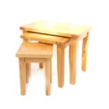 A light oak nest of occasional tables, with rectangular tops and slightly square tapered legs, the