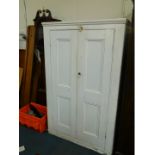 A Victorian white painted wooden silver cupboard, the outswept pediment over two doors, opening to